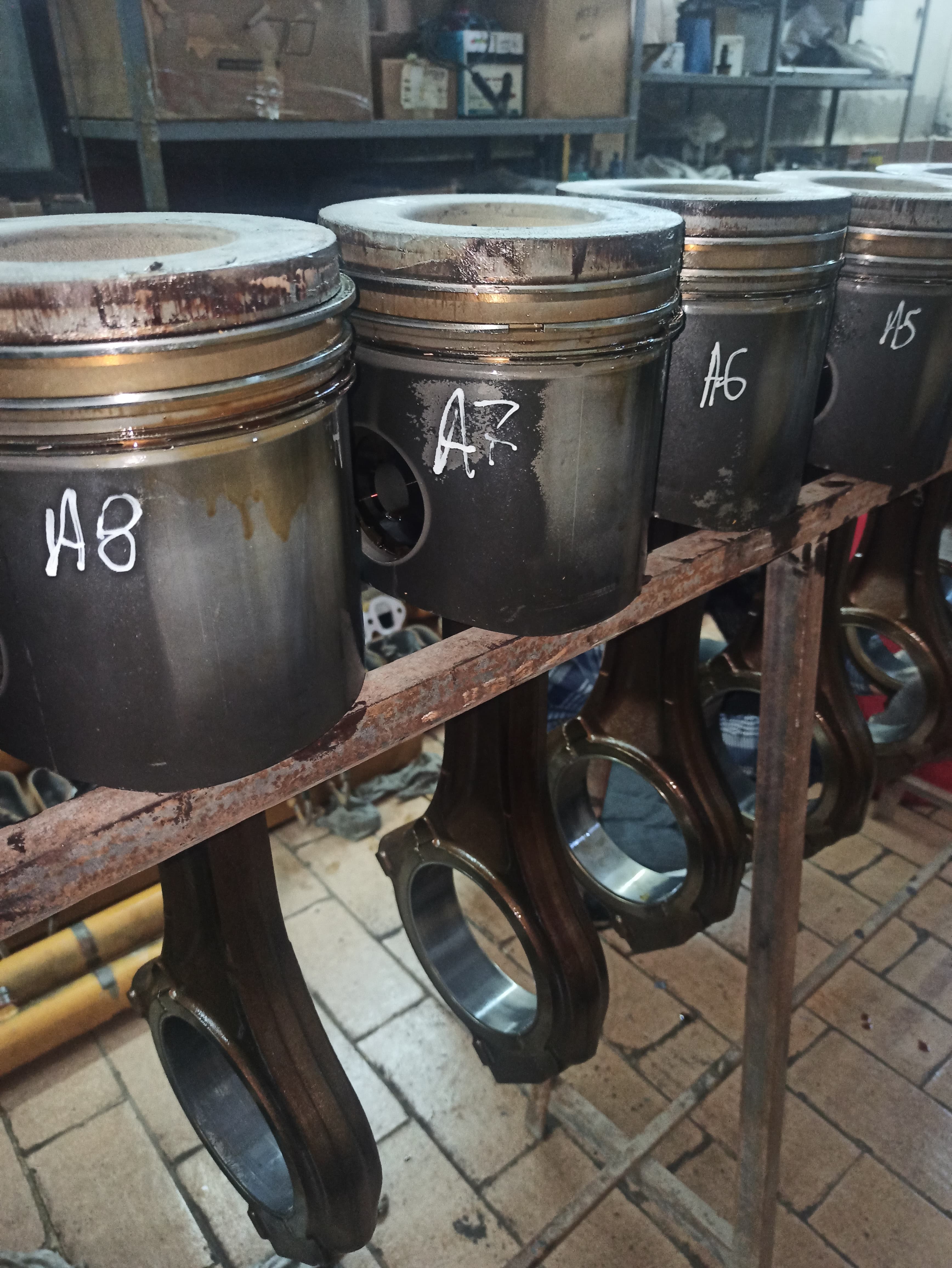Engine pistons and connecting rods laid out during overhaul