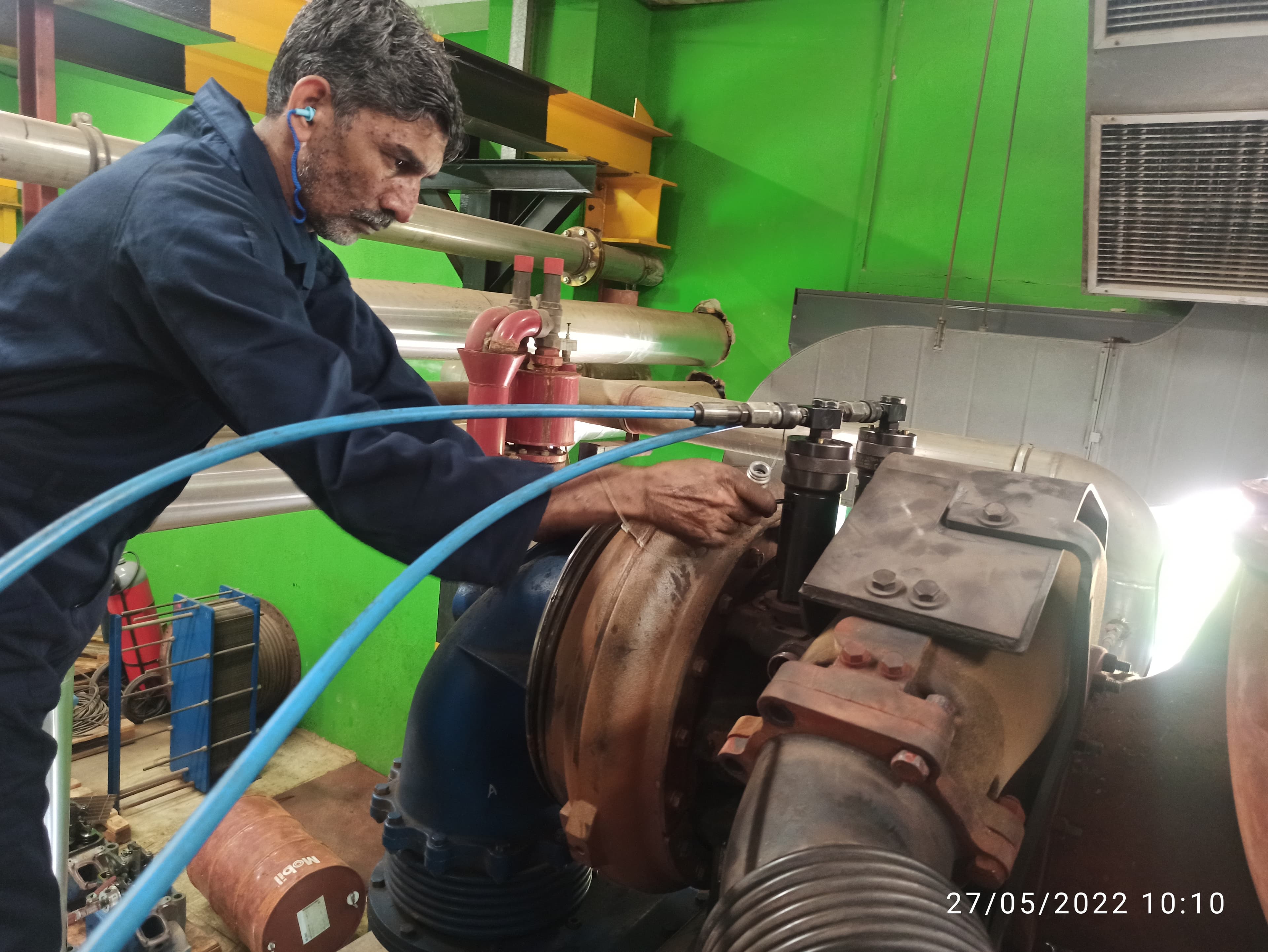Technician servicing turbocharger on engine