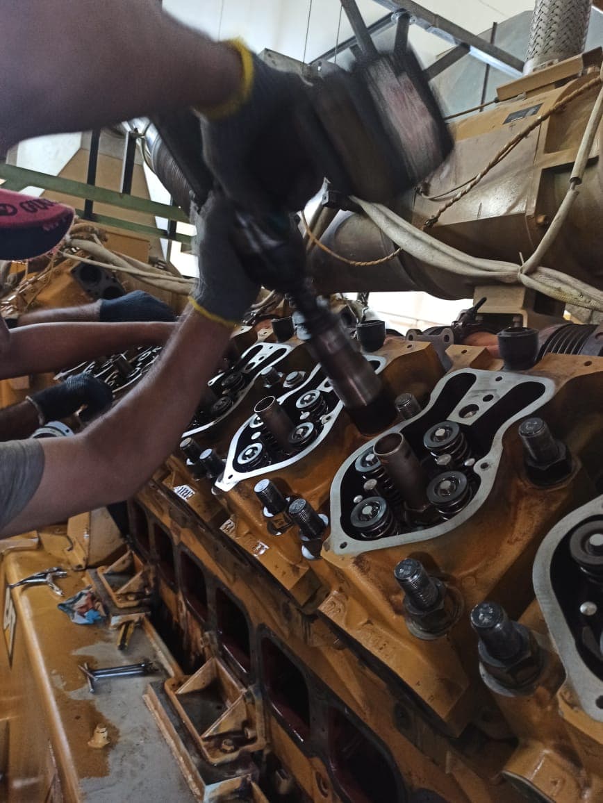 Technician working on engine cylinder head valves